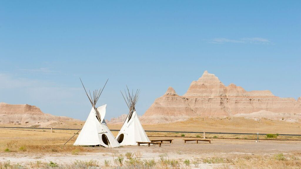 Image of teepees in the Dakota badlands 
