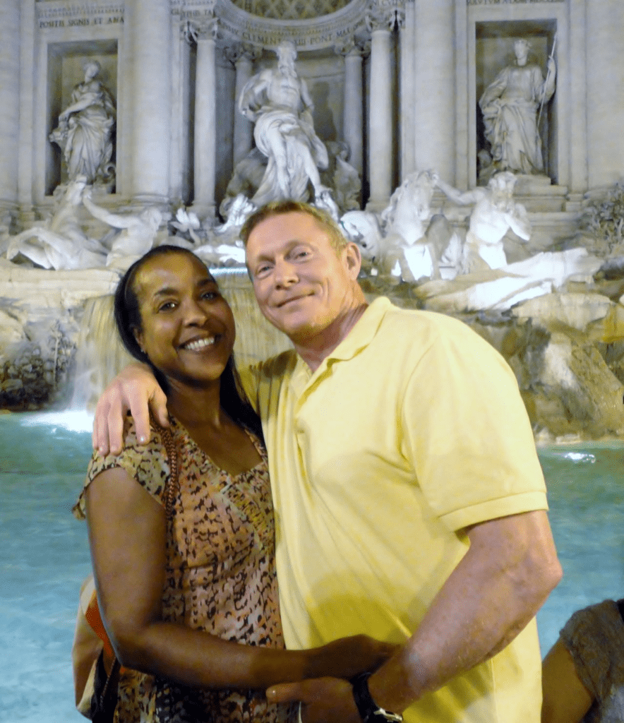 Couple taking a photo by a fountain in Rome