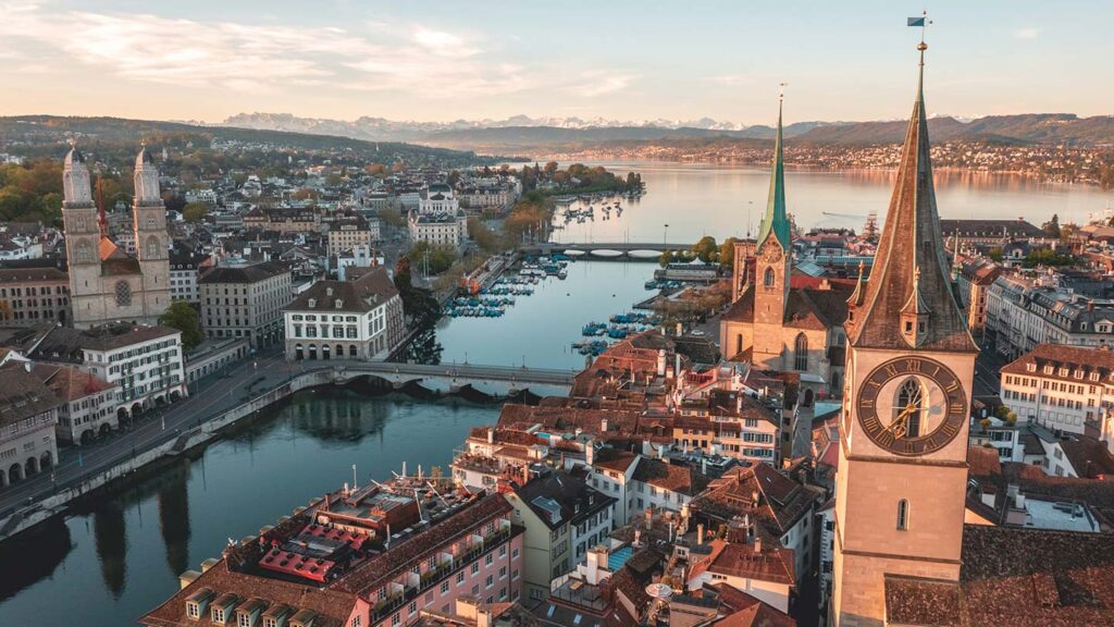 Aerial image of Zürich, Switzerland, with Lake Zürichsee in the background and the Alps in the distance