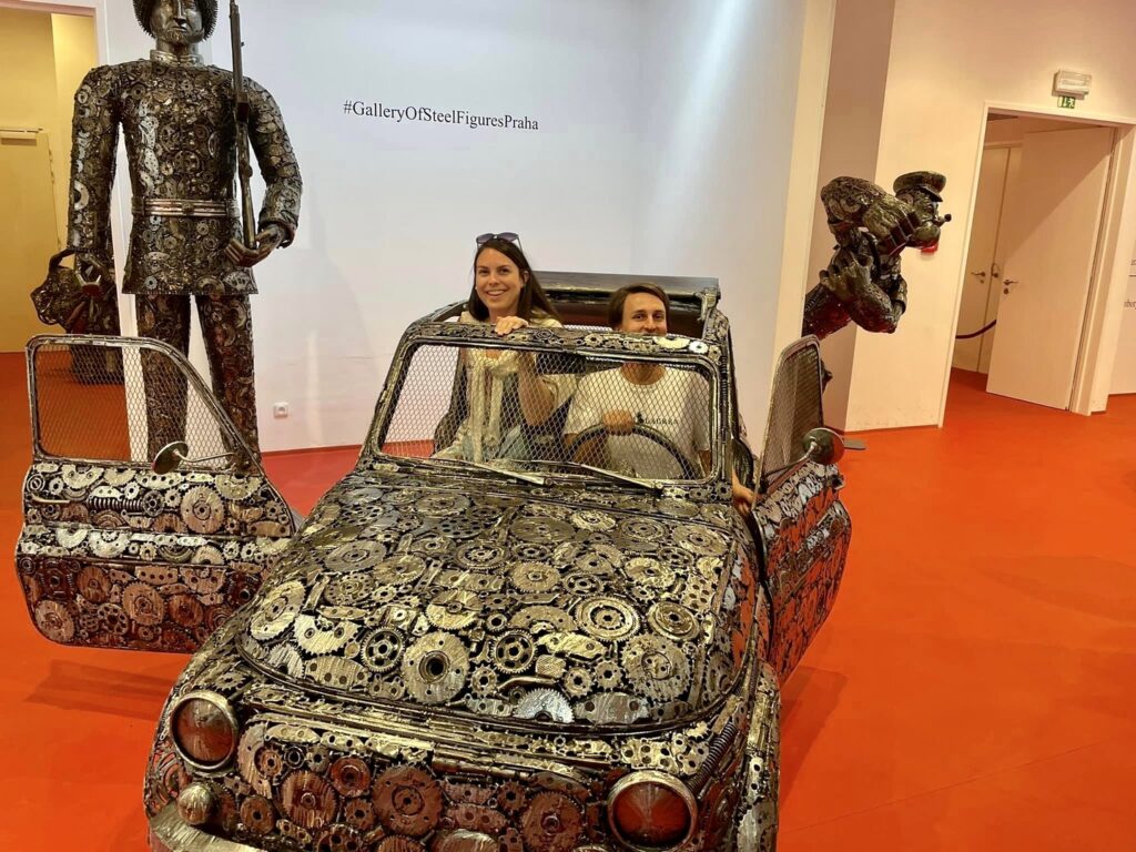 Madeline and her husband posing for photos at the Gallery of Steel Figures museum in Prague - Trafalgar Unlocked Award winners