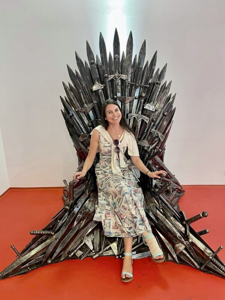 Madeline posing for photos at the Gallery of Steel Figures museum in Prague