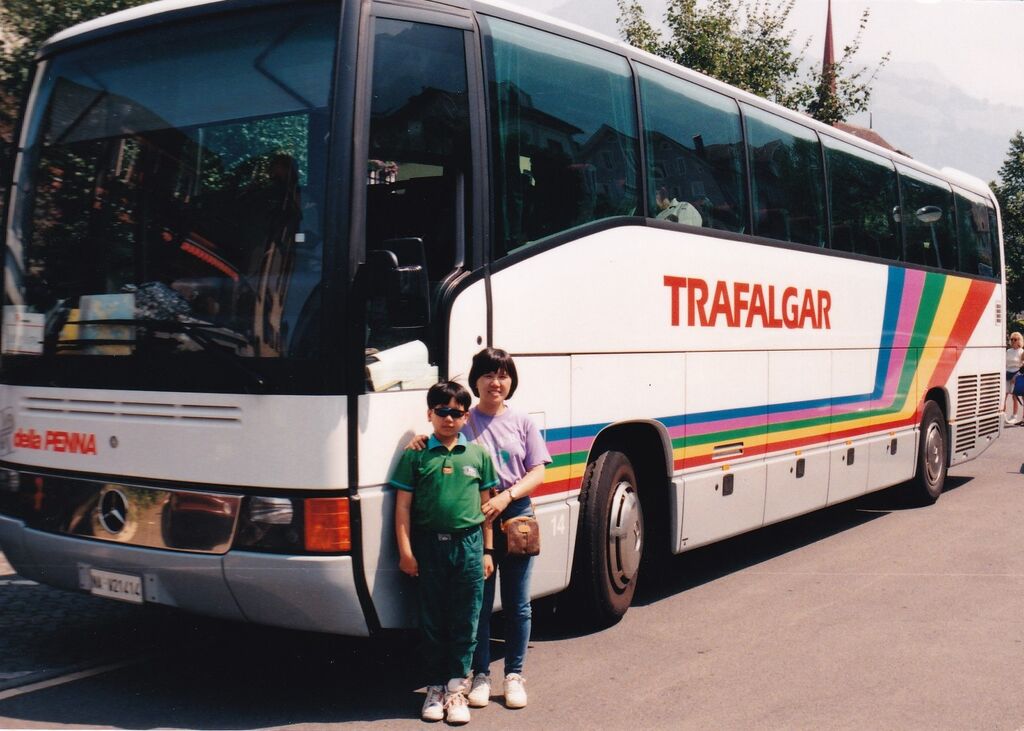 Son and mum posing outside of a Trafalgar travel coach