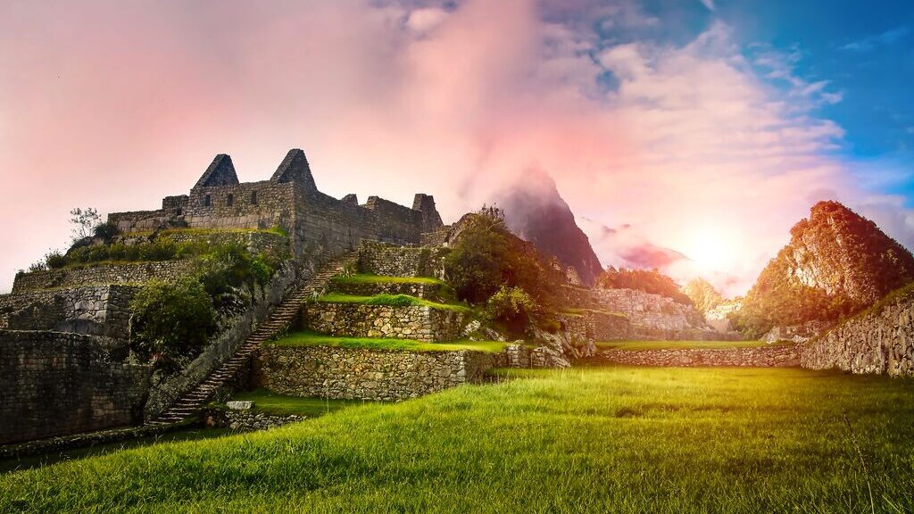 Macchu Picchu from an interesting angle, with pink clouds and blue skies
