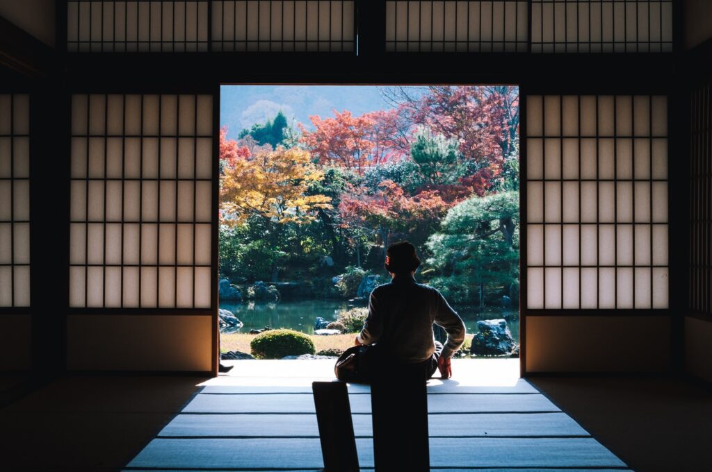 person looking out over a peaceful garden in Japan