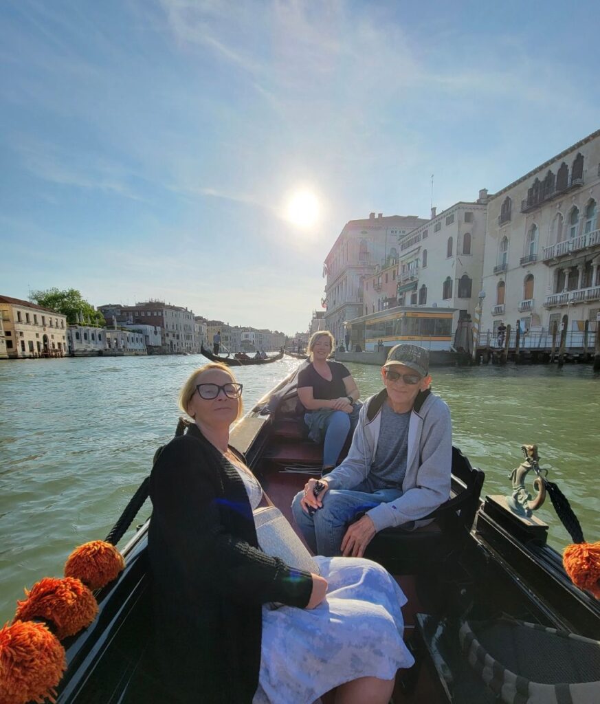 Family posing for photo on a gondola in Venice