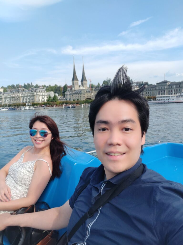 Benedict and his wife on a paddle boat in Lake Lucerne Switzerland