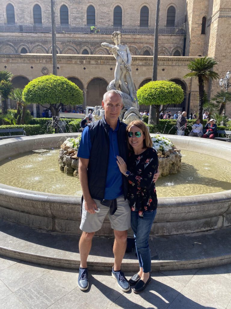 Jeff and Tina pose together by the fountain after the proposal