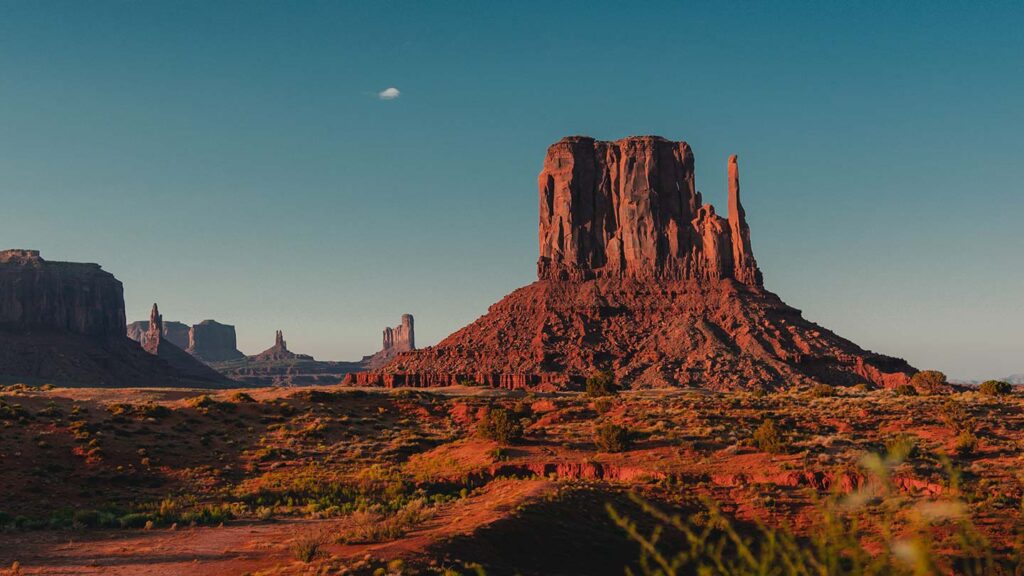 Image of Monument Valley's red rock mesa against a cloudless blue sky