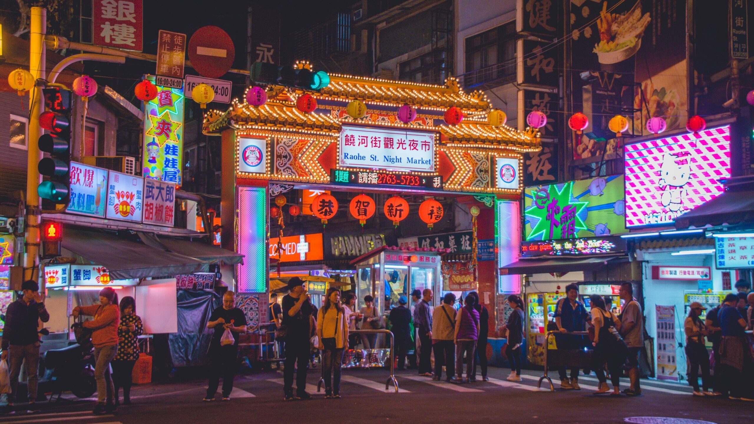 Taipei by night, with bright screens and neon lights lighting up the buzzing street below. Taipei is one of the most LGBTQ friendly cities in Asia.