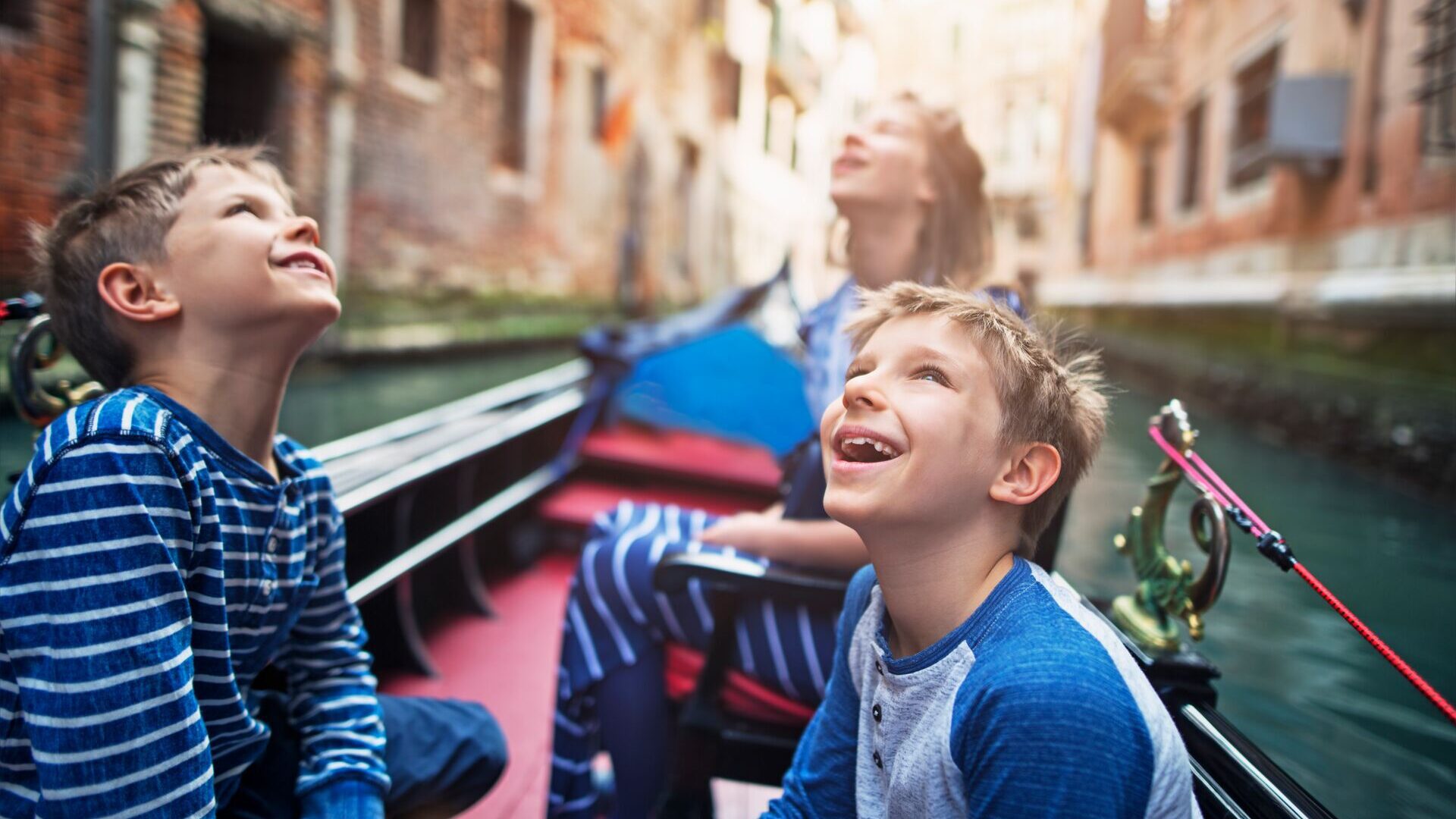 children enjoying a gondola cruise, Venice, Italy
