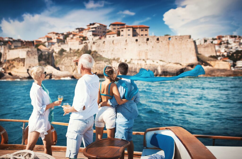 couples looking at coastline from sailboat