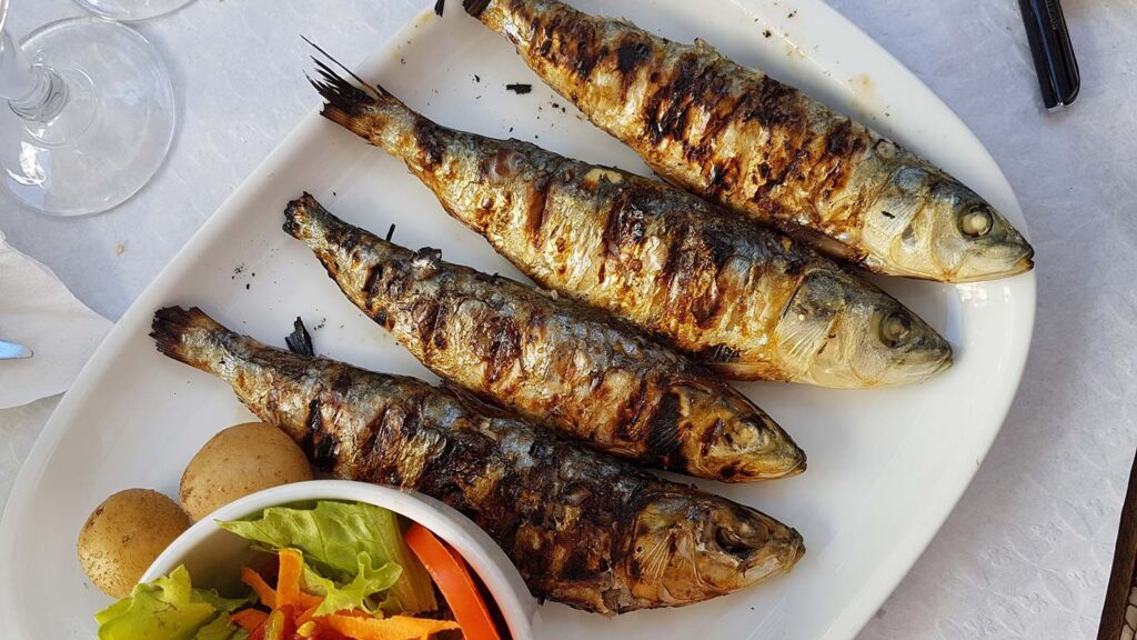 A plate of fried fish and vegetables.