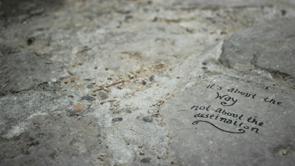 Writing on stone that says 'it's about the way not about the destination' 