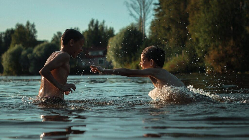 Two boys playing in a river