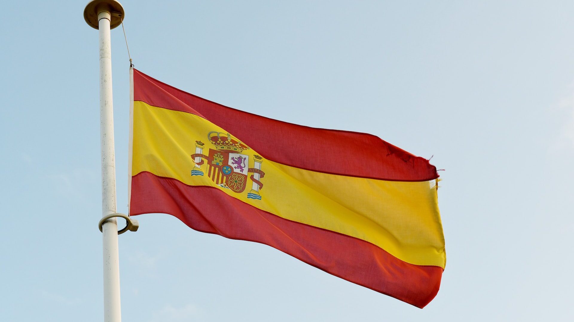Portuguese flag with blue sky in background