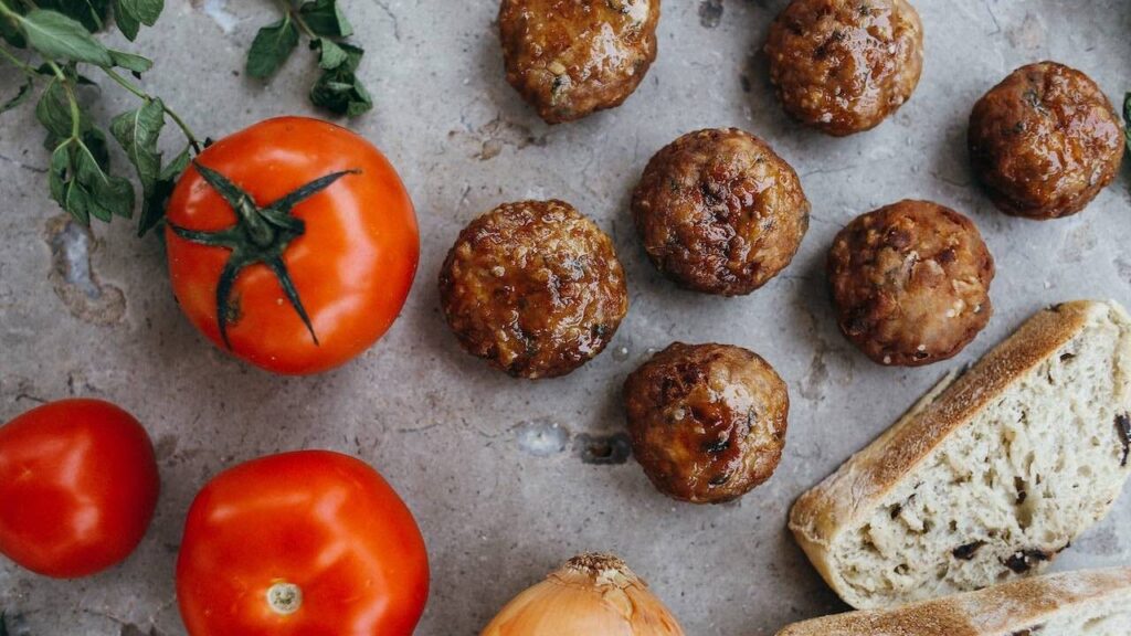 Meatballs on table with tomatoes