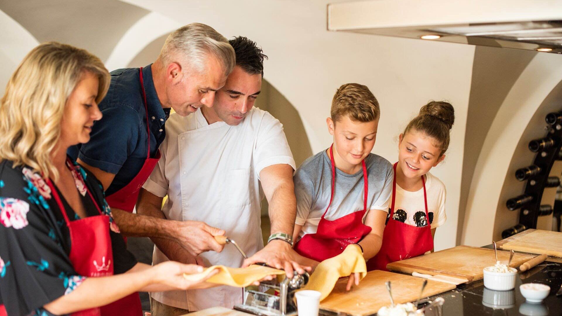 Family in a pasta making cooking class