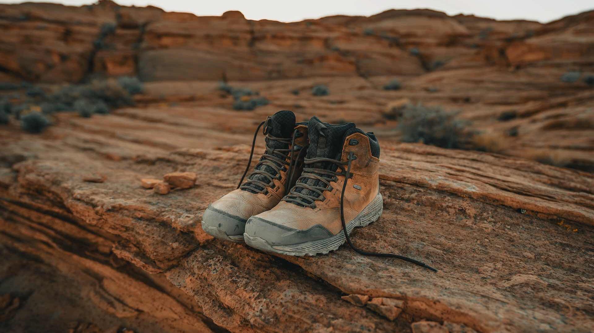 Brown hiking boots on rock