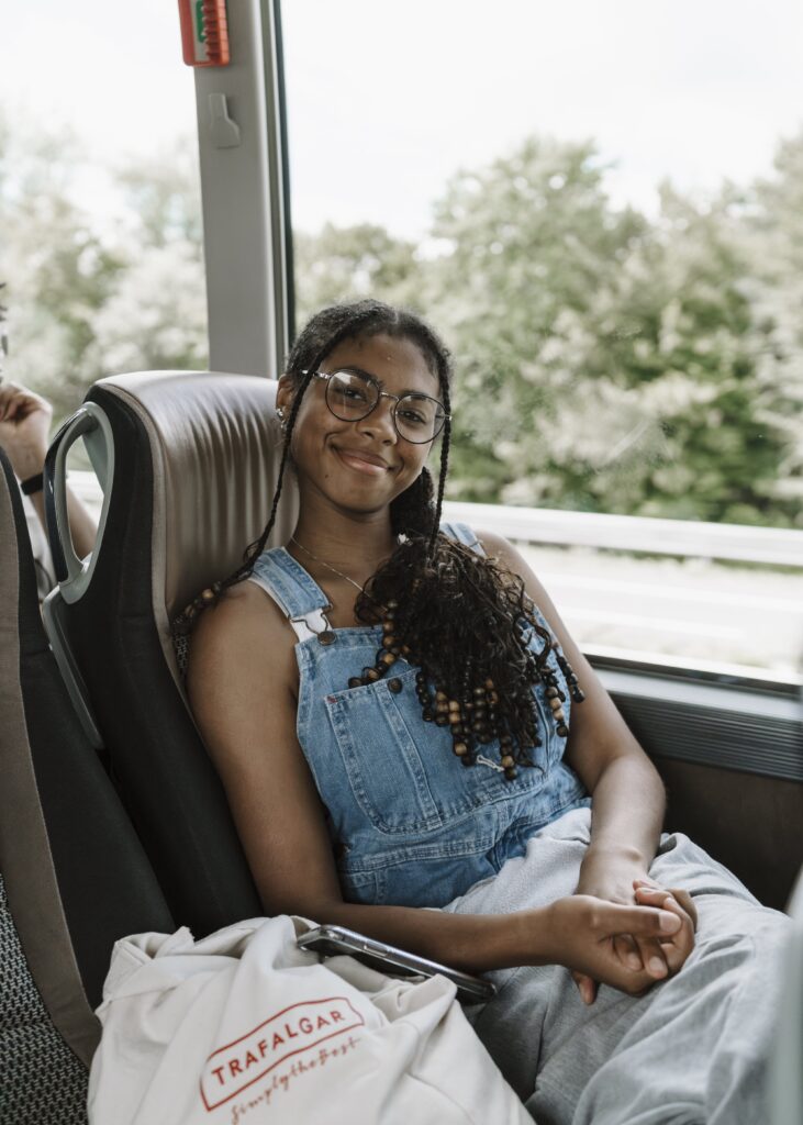 Avery, smiling, enjoying Trafalgar travel tours while on a coach on the Balkans Delight trip
