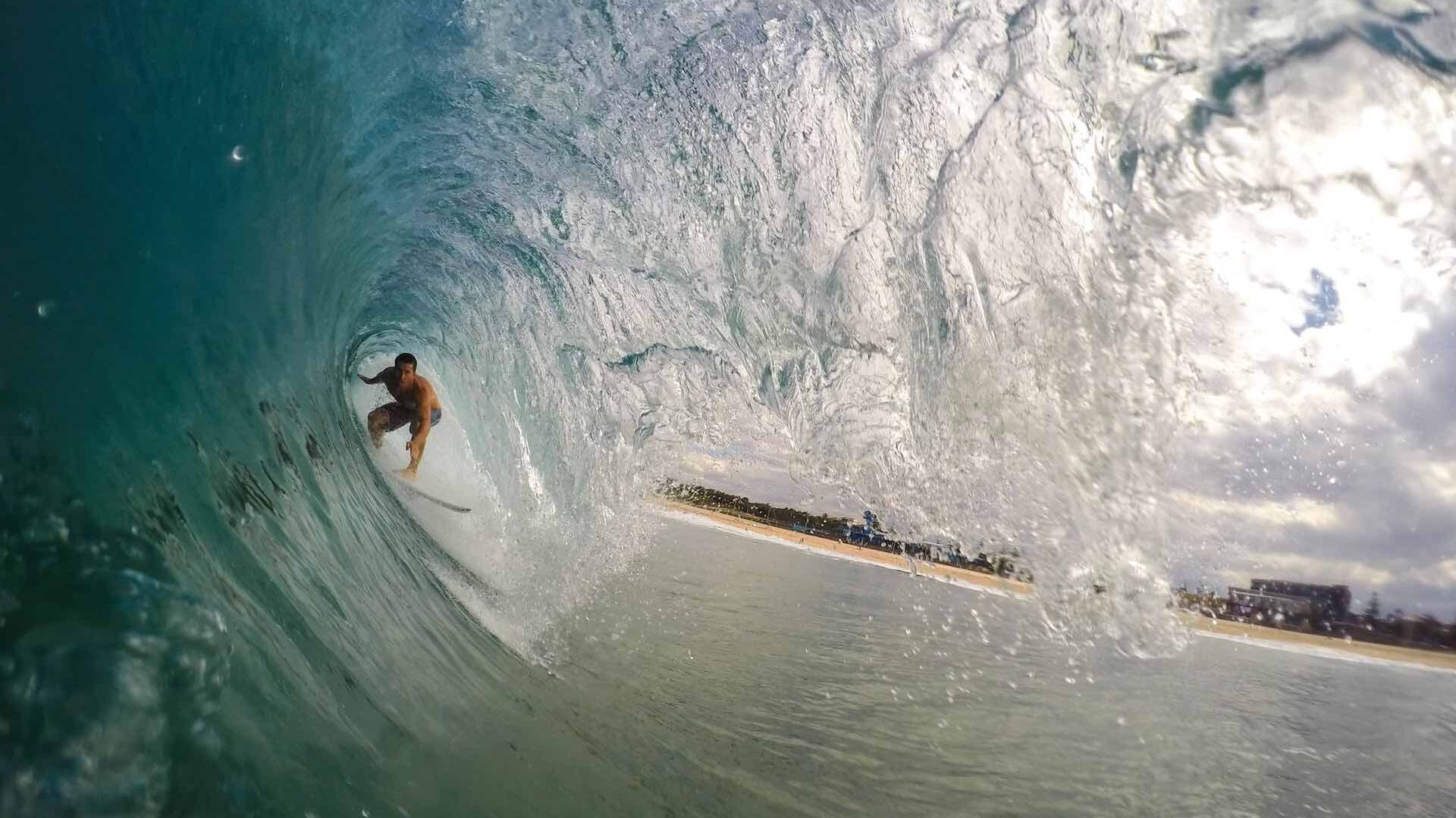 Close up of surfer riding wave surrounded by water
