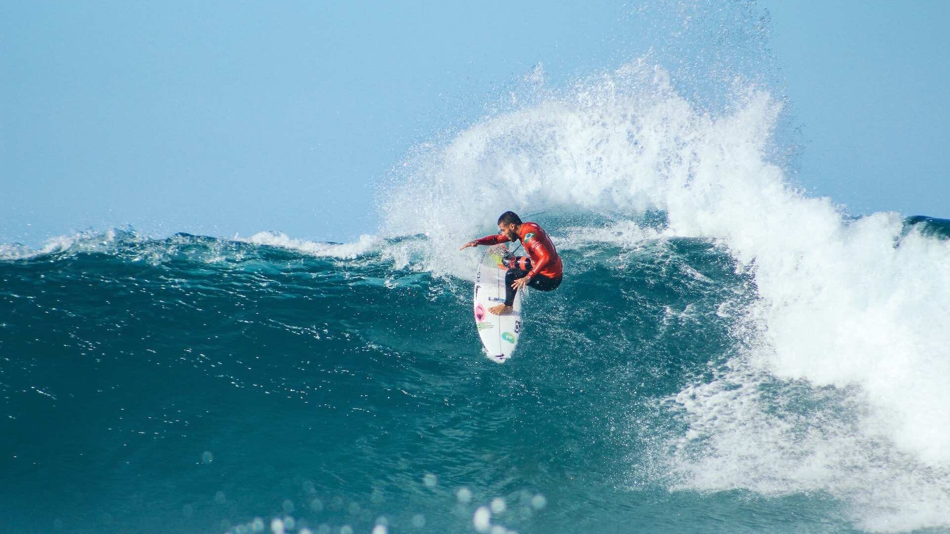 Surfer riding big wave