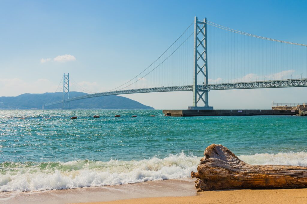 A wide angle photo of the glorious suspension bridge in Awaji, connecting the Japanese Islands over a vast stretch of ocean