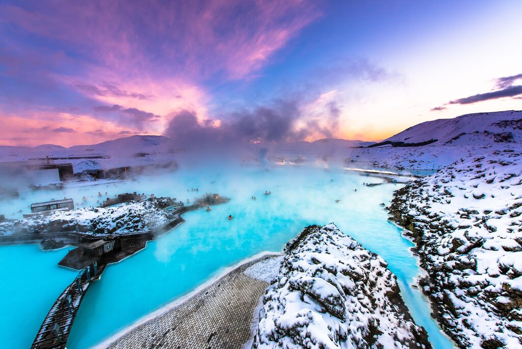 The blue lagoon, surrounded by snow and a purple-azure sky.