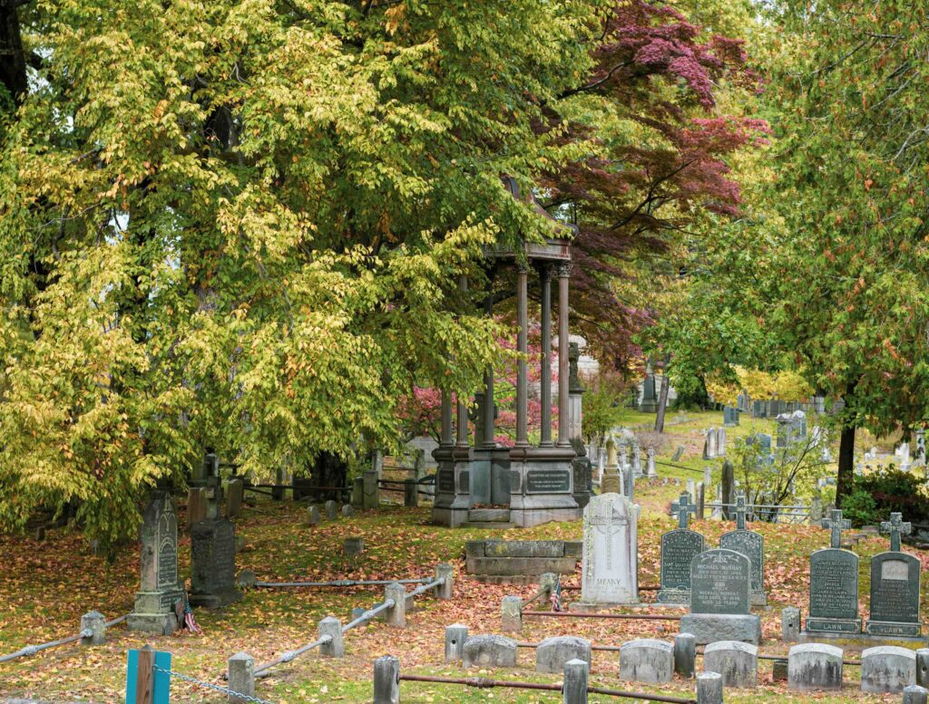 Sleepy Hollow, NY, one of the best places to visit for Halloween. Close-up of a graveyard, with stones visible and trees in the background