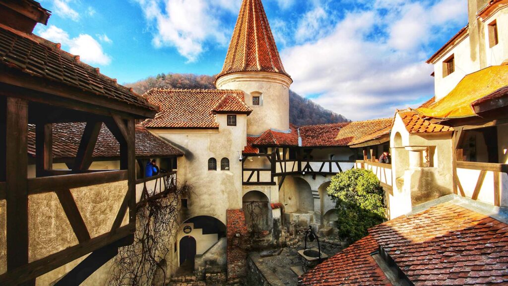 Inside of a castle in Transylvania, turret in the center and background. This destination is one of the best places to visit for Halloween