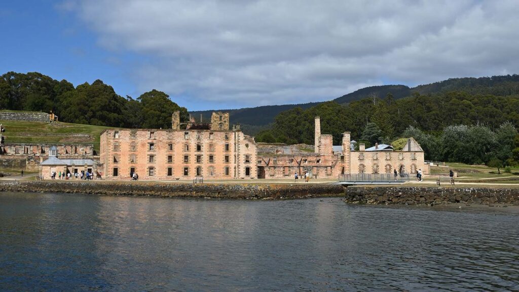 Port Arthur in Australia, can see the ruins of the building on the port with greenery behind it.