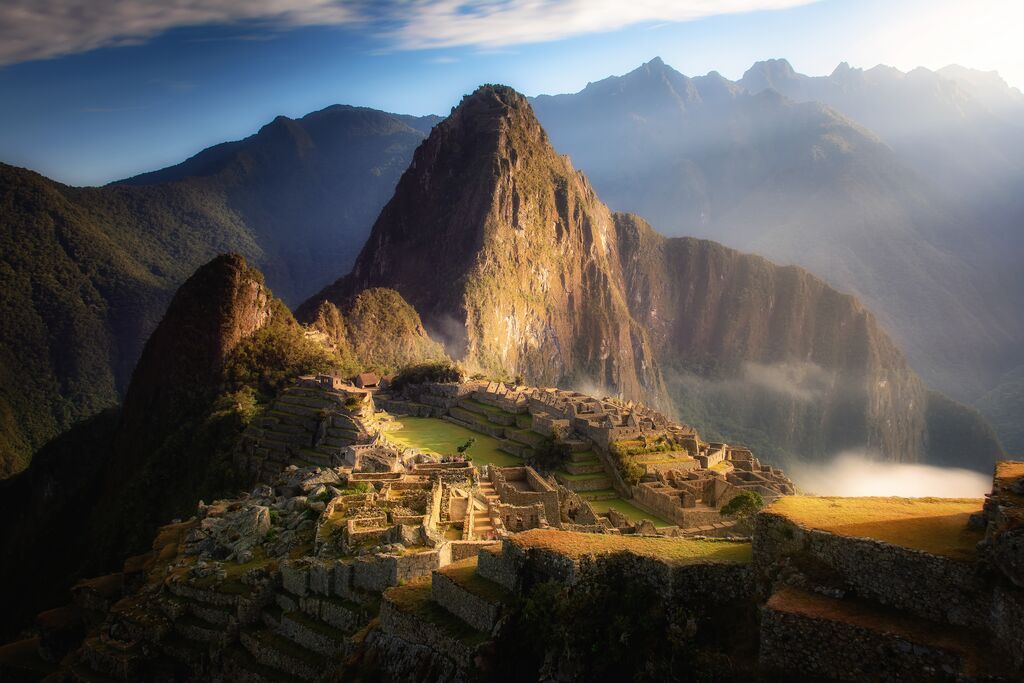 Machu Picchu at golden hour, lit up with beautiful light.
