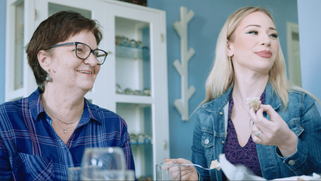 Senada and Jasmina laugh together in their home in Sarajevo, Bosnia