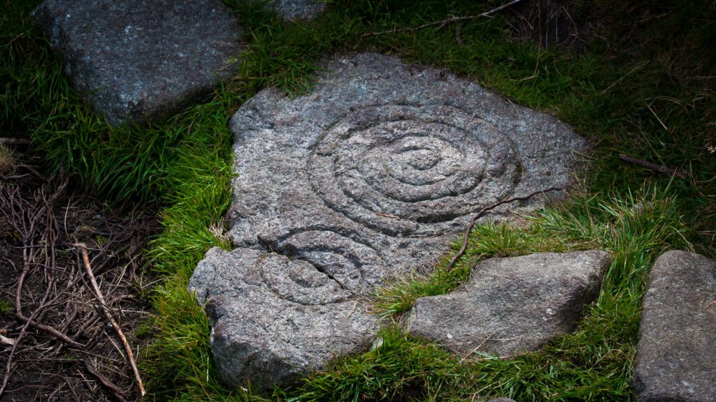 Closeup of a stone in Tibradden with ancient rune symbols carved into it.