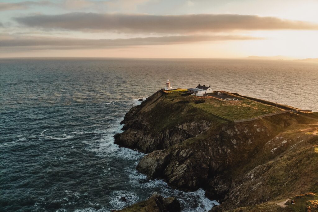 The best of Ireland's landscapes: a lighthouse on the end of a small peninsula jutting out into the ocean.