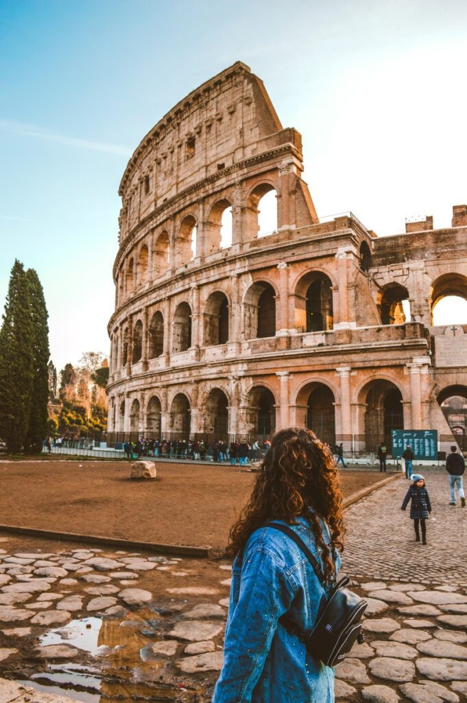 traveller standing in front of the Colosseum in Rome