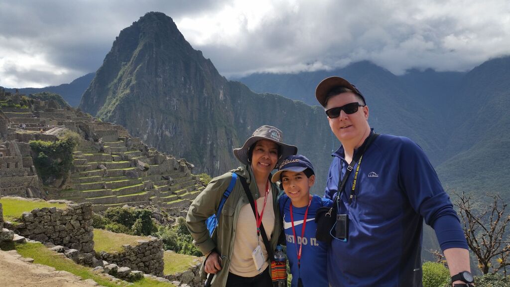 Past Trafalgar guest Nurys A. in a photo of Machu Picchu with her husband and son