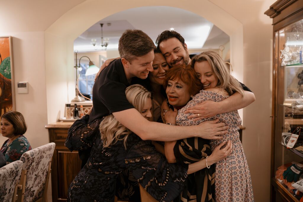 Group of Trafalgar guests hugging each other