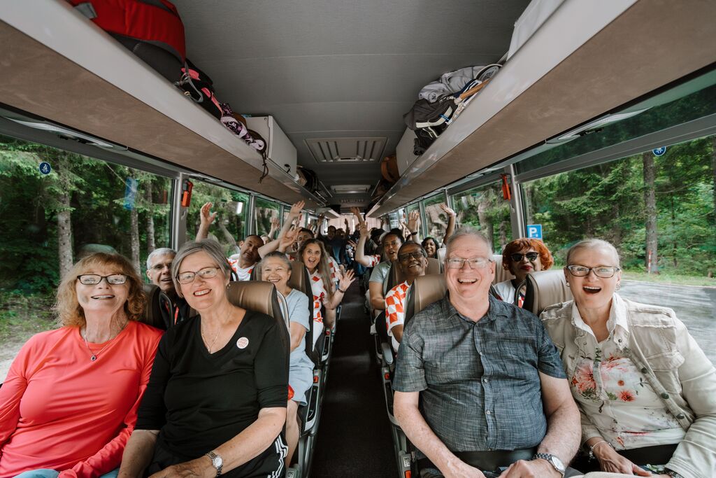 Group of Trafalgar guests inside a coach, smiling at the camera