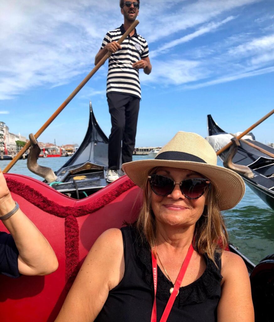 Trafalgar past guest Suzanne on a gondola in Italy