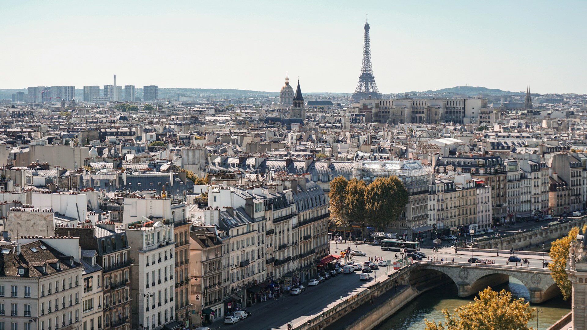 Cityscape view of Paris. River Seine in the foreground, looking towards the Eiffel Tower in the distance.
