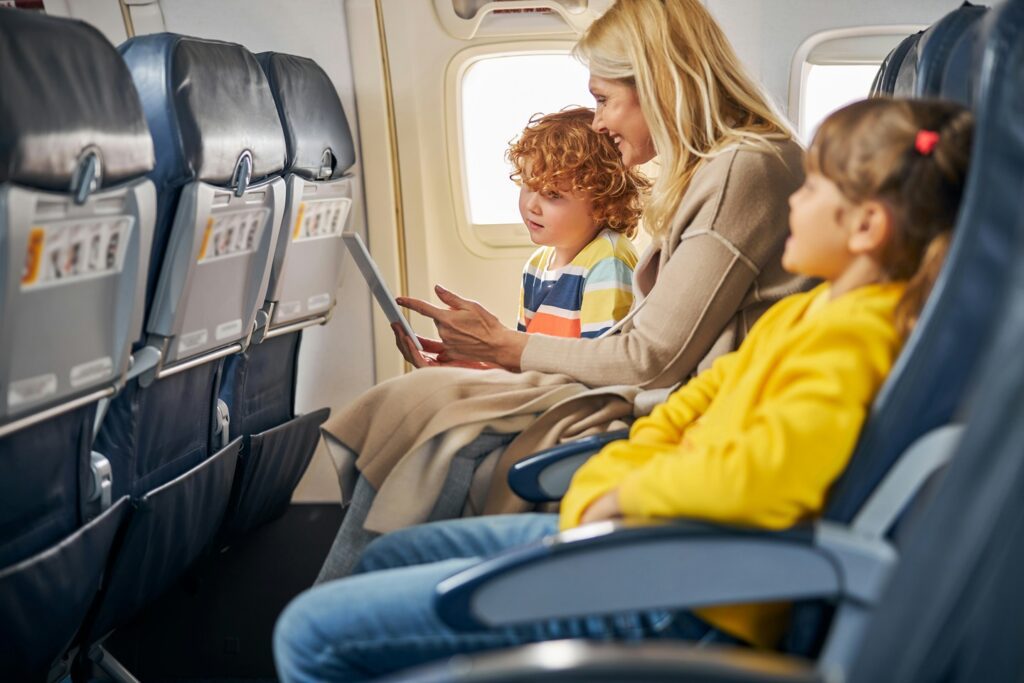 parent with two children on an airplane