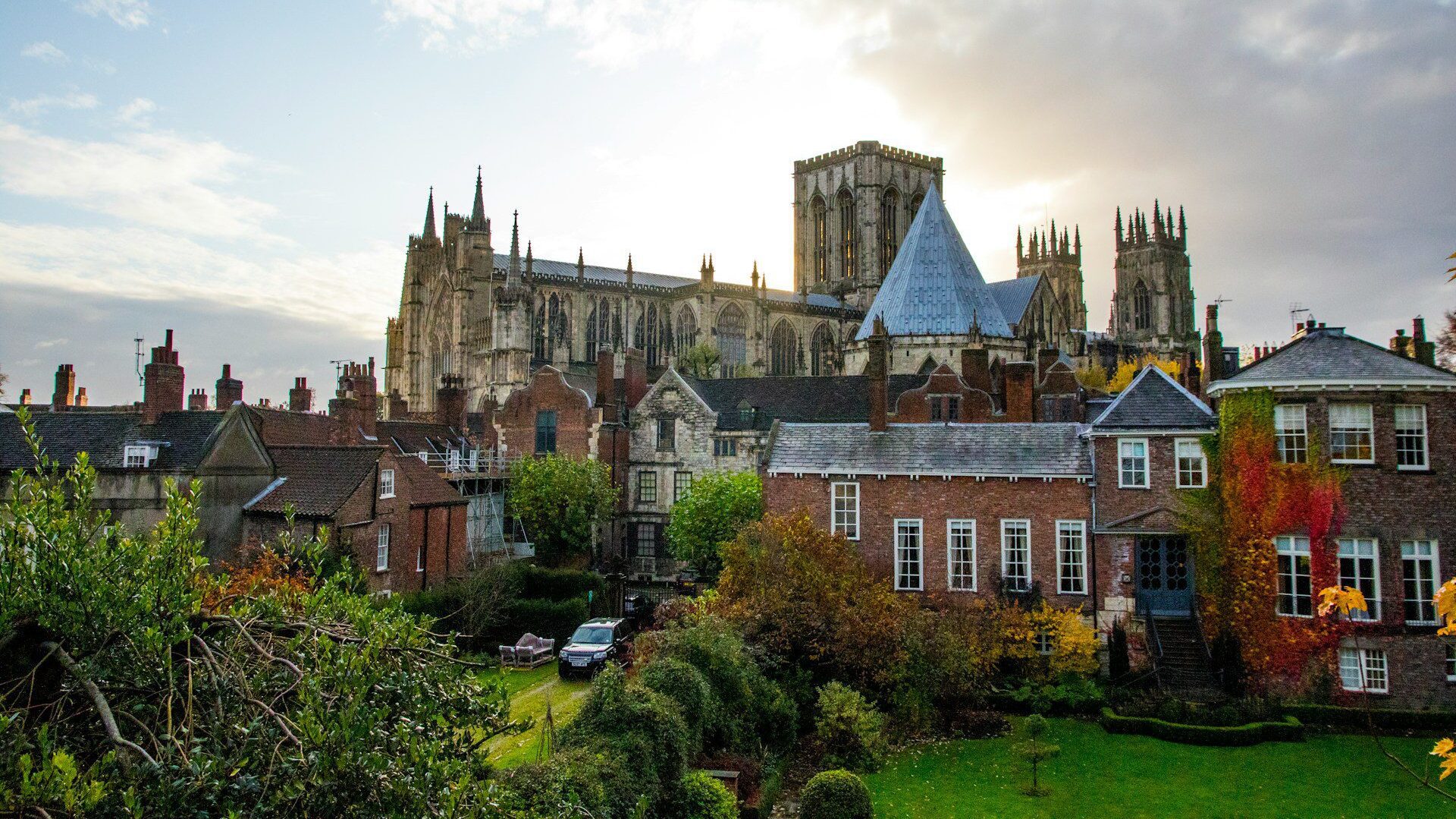 Photo of York minster, peeping above the residential rooftops of the City of York
