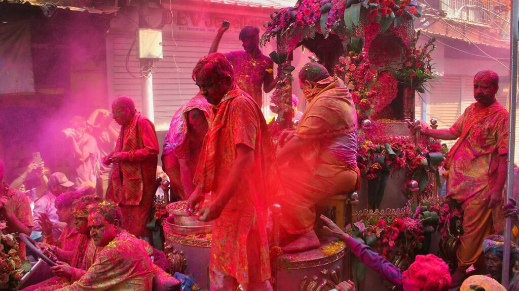 A religious float covered in colored powder at Holi