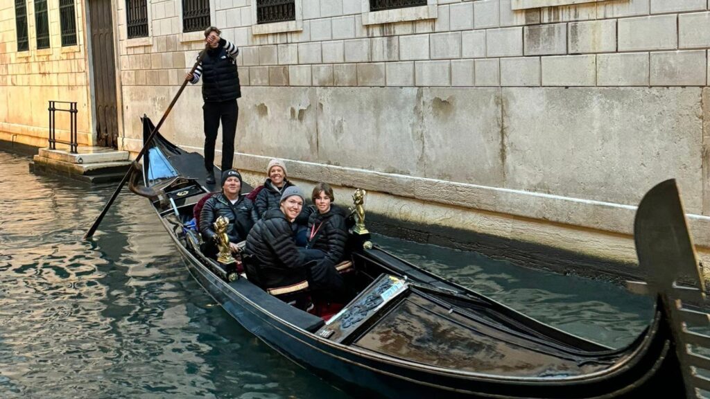 Rebecca and her husband and two sons on a gondola in Venice