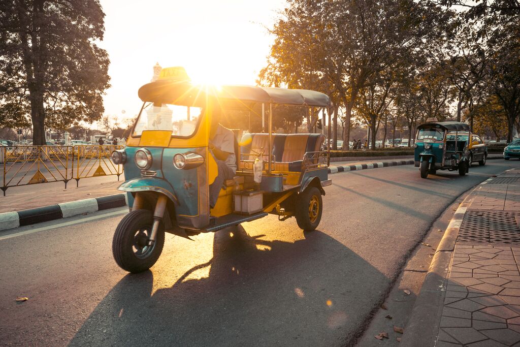 A tuk tuk in the golden hour sun in Bangkok, Thailand