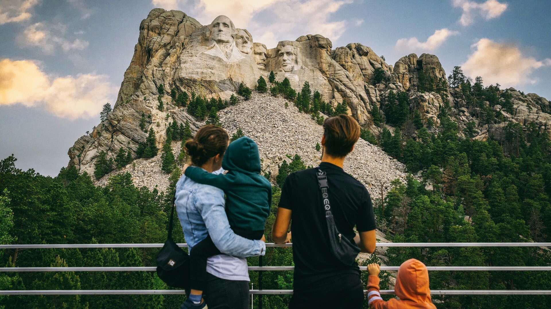 Young family looking at Mount Rushmore