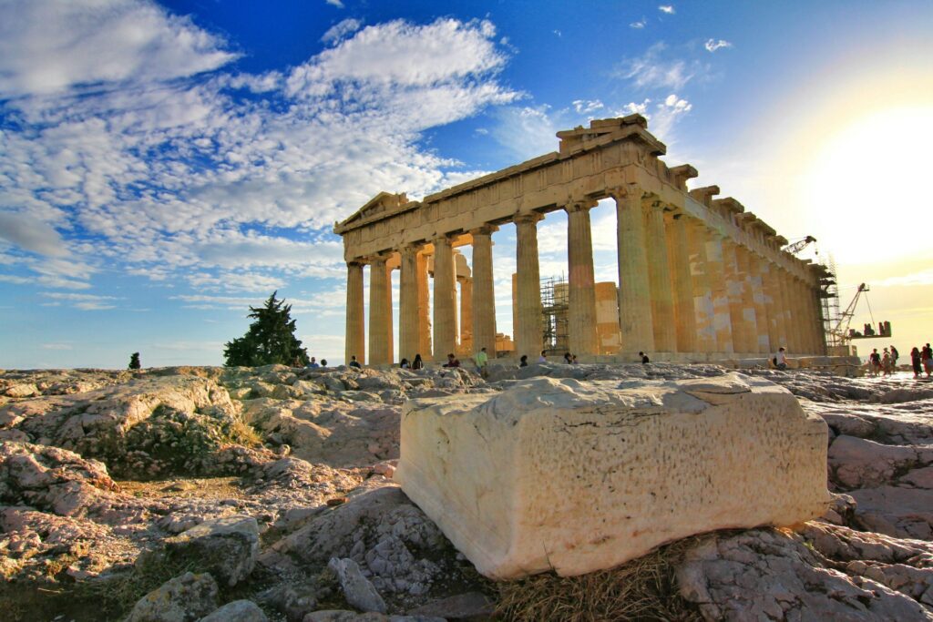 Photo of an ancient temple in Greece against a blue sunny sky
