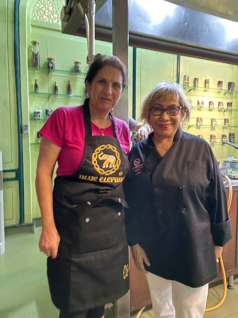 A Trafalgar guest posing for a photo at Blue Elephant, Thai cooking class