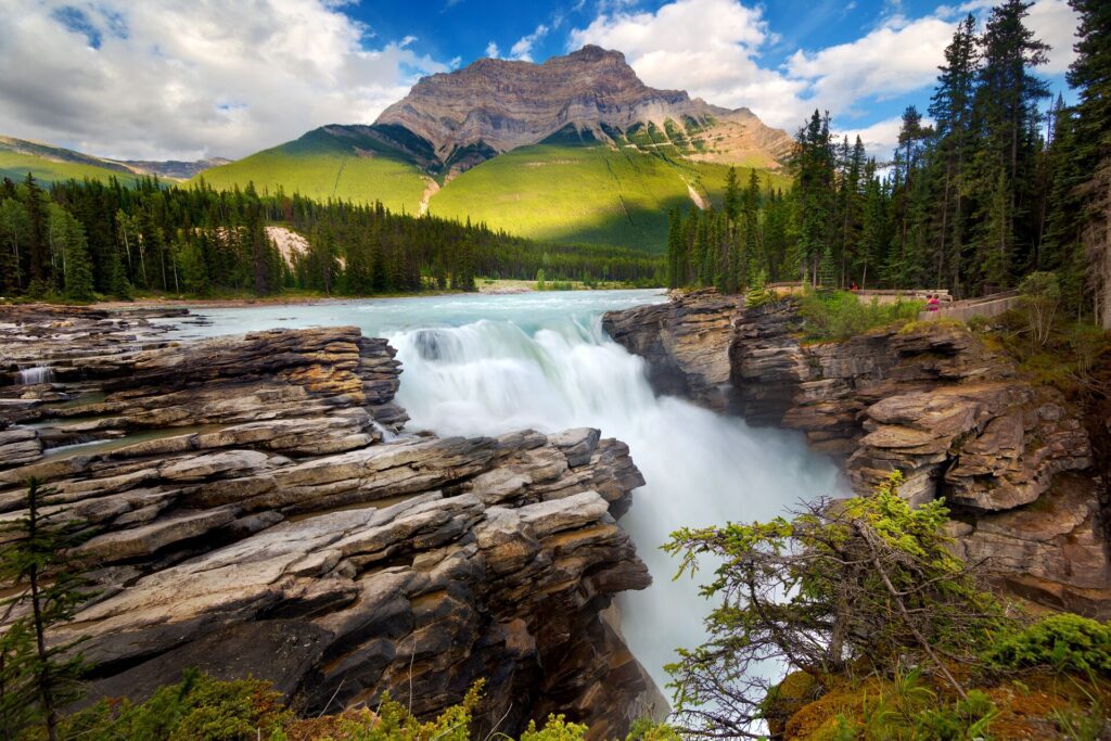 A mountain, forest, waterfall and rocks are on display in Canada in August