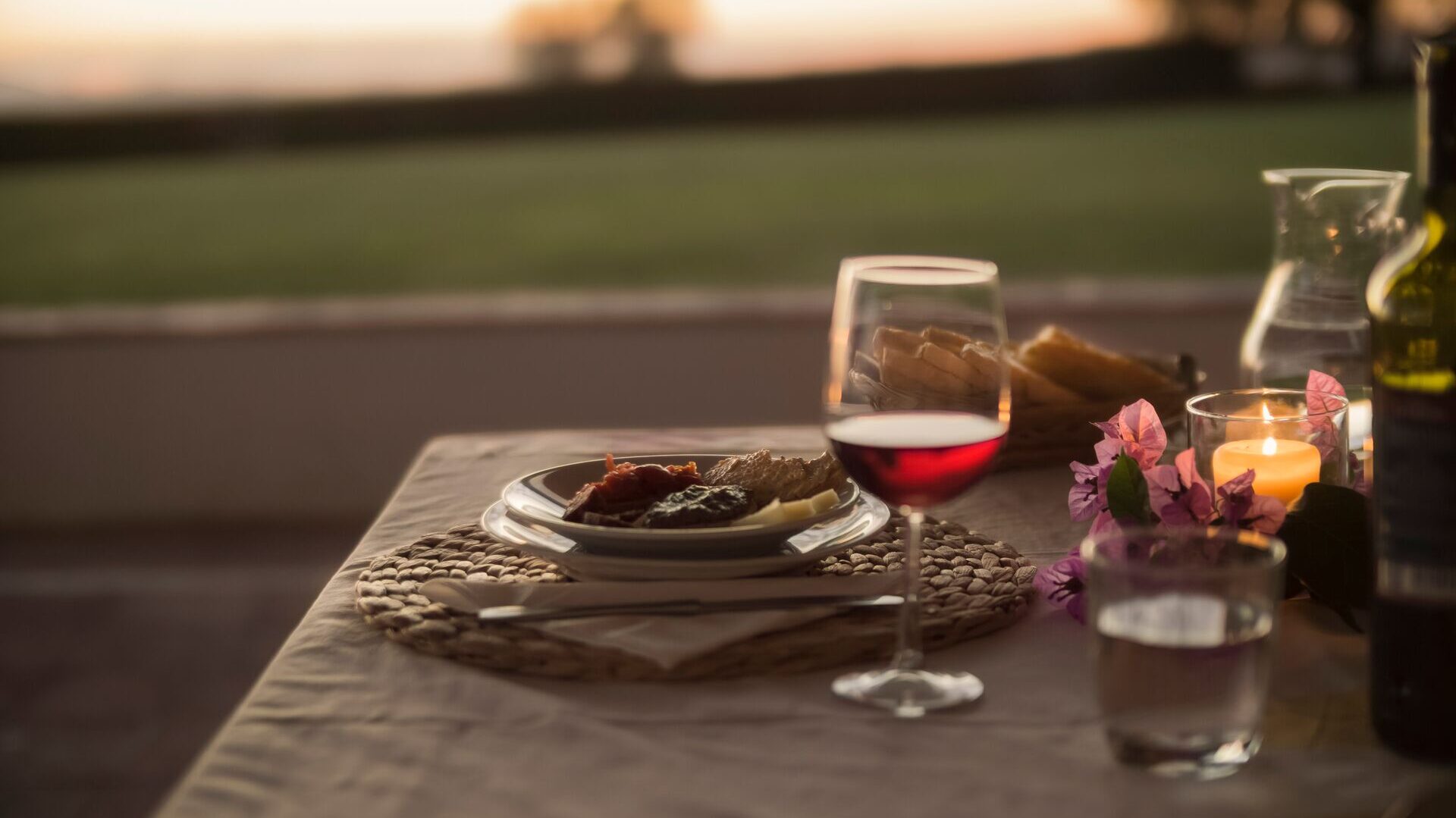 Dinner table in tuscany with wine glass half full